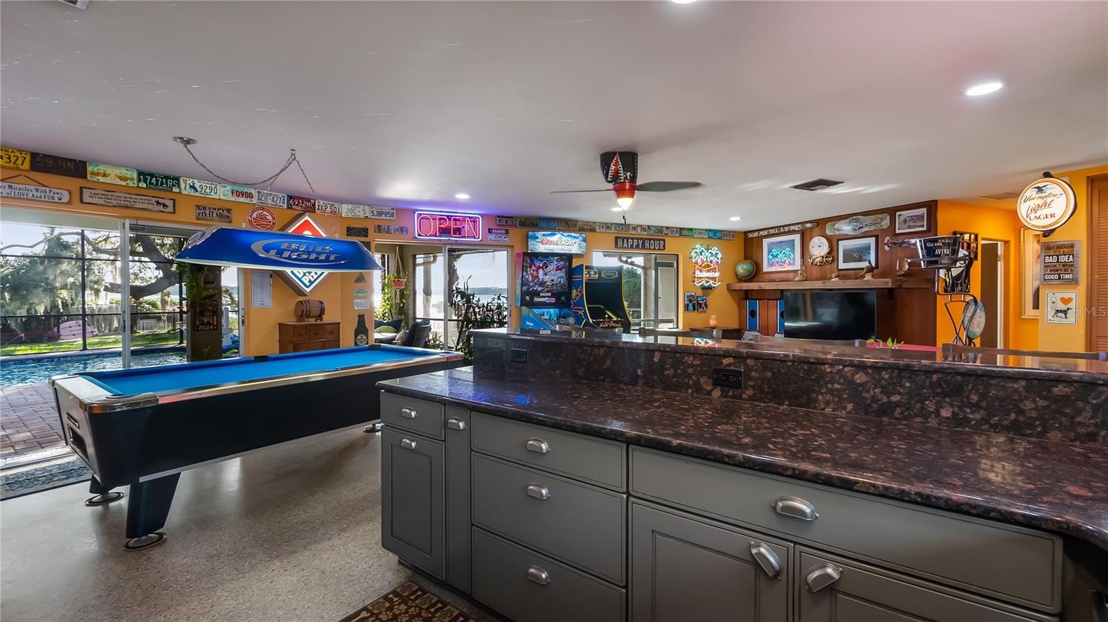 Main Home - Great room/kitchen/living room combo: Living room used as gathering space for game room fun. Two Sliders go out to covered back porch and 