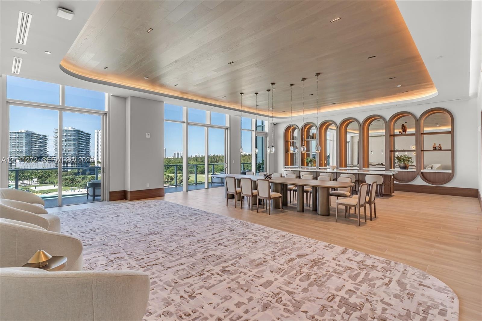 Expansive open-concept space featuring a wood-plank tray ceiling with integrated cove lighting, floor-to-ceiling glass paneling, wood-finish flooring,