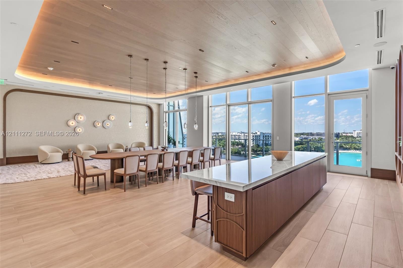 Expansive space featuring a curved wood-slat ceiling with recessed perimeter lighting, floor-to-ceiling windows, wood-finish tile flooring, and a larg