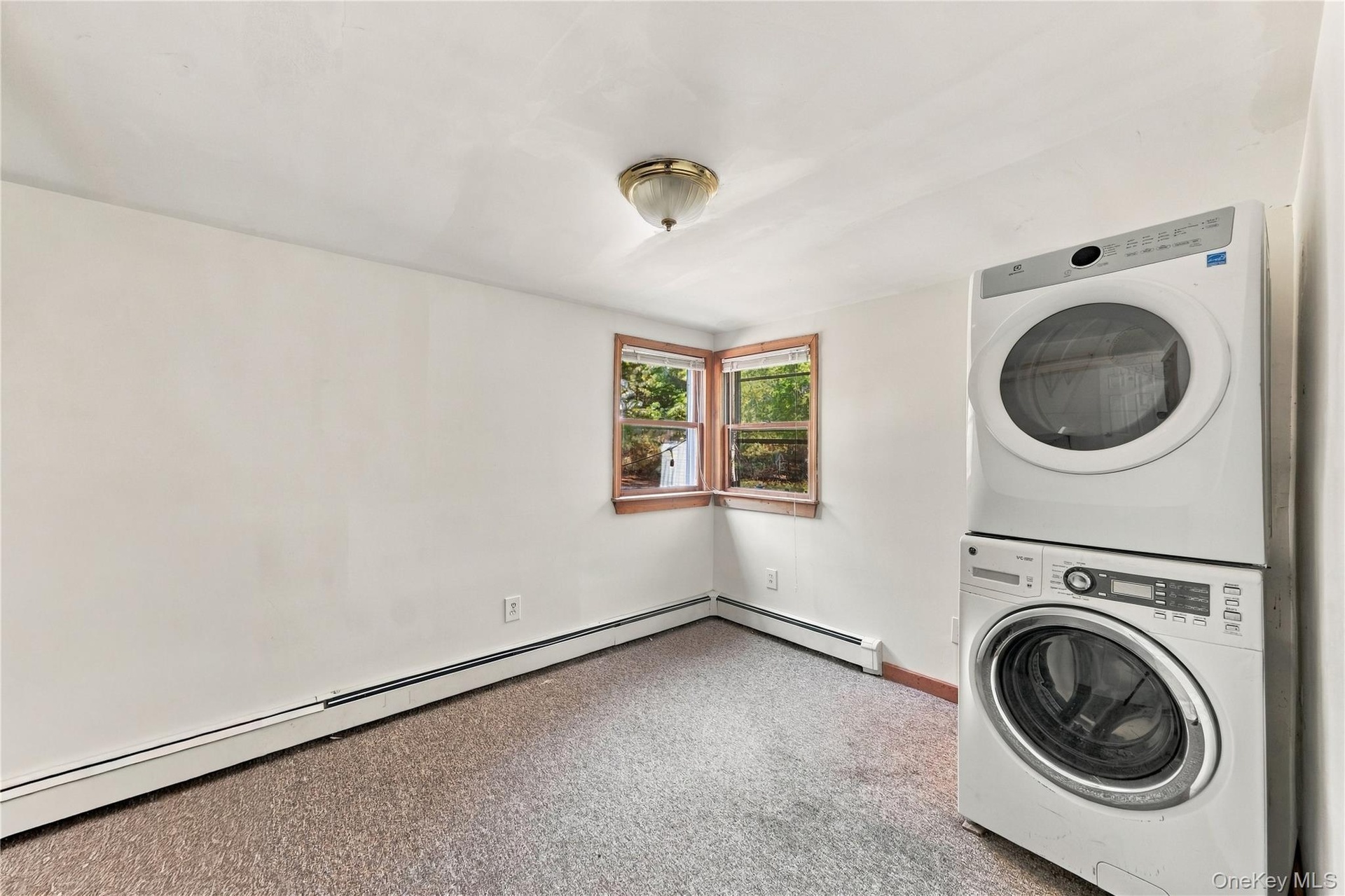 Freshly painted bedroom with stackable washer/dryer