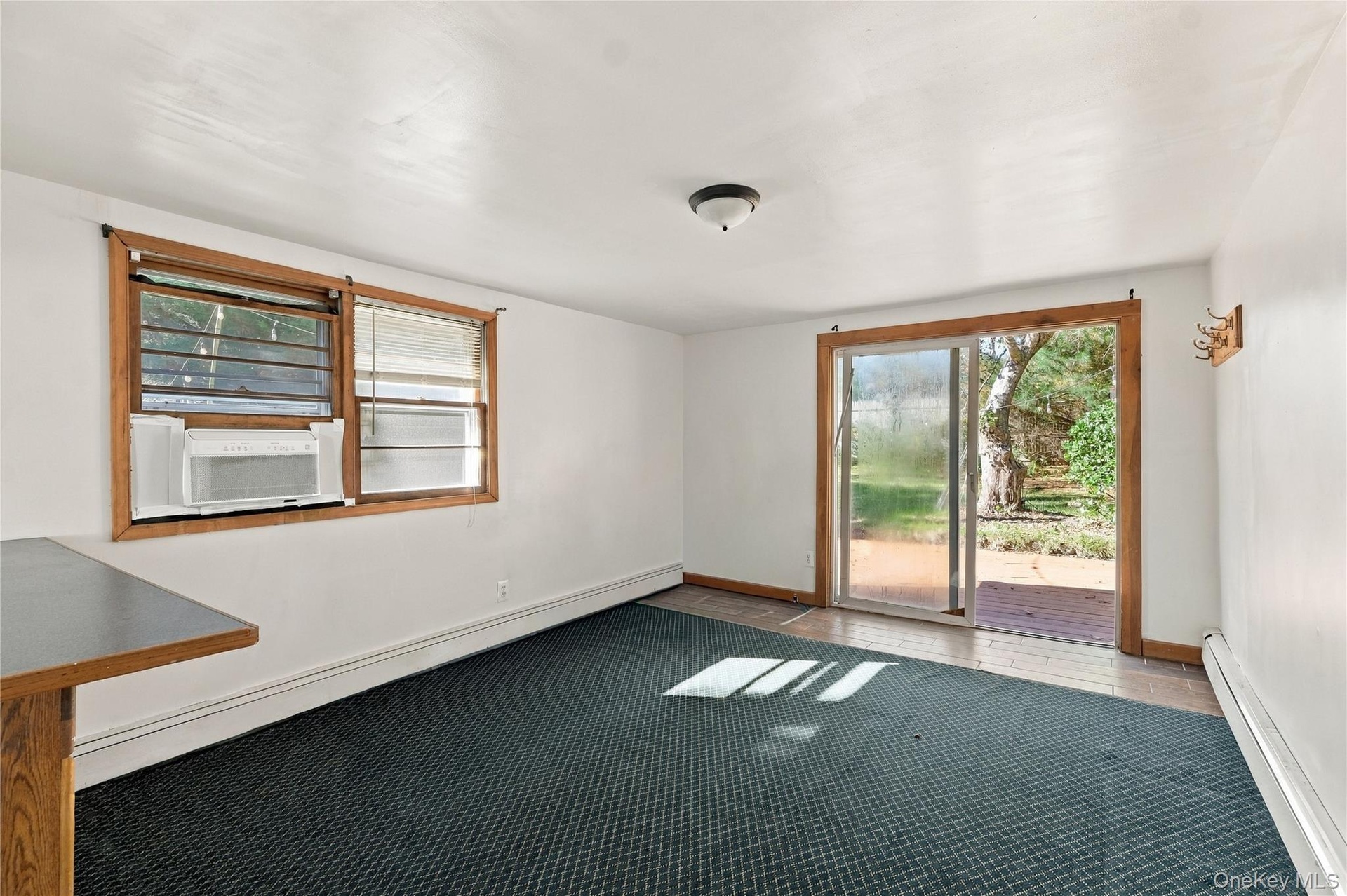 Freshly painted living room with sliding glass doors and wood-framed windows