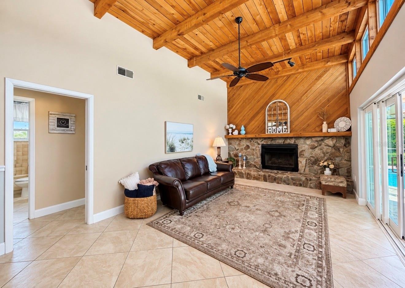 Family room with natural light and fireplace off 2nd and 3rd bedroom hallway