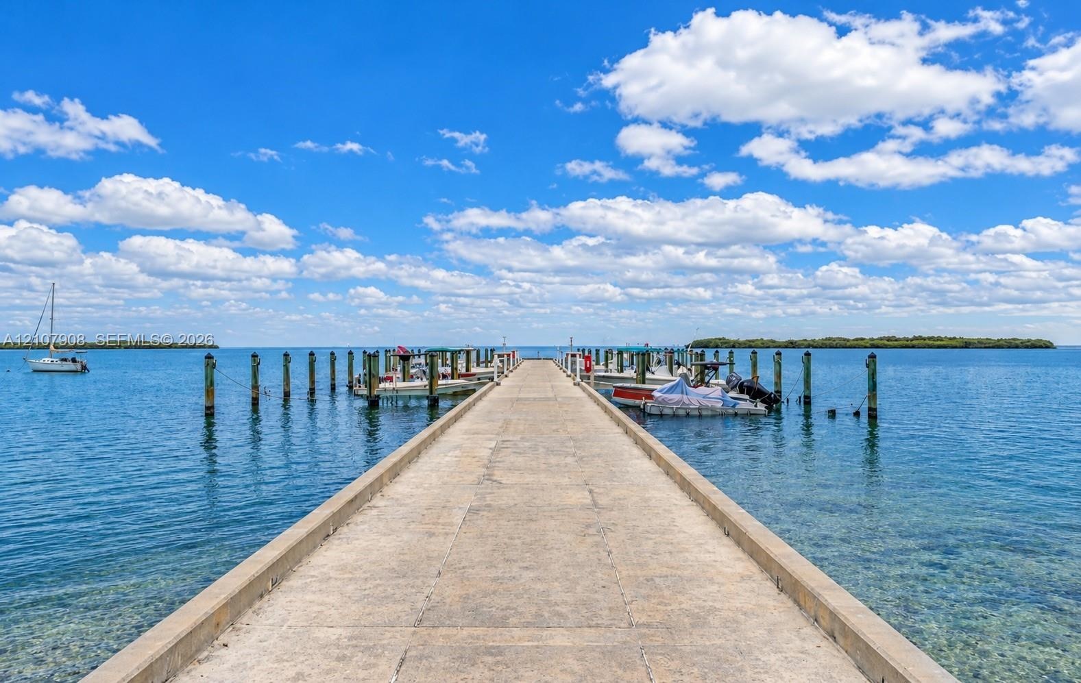 Concrete deep-water dock featuring multiple pilings for watercraft mooring and open-water access