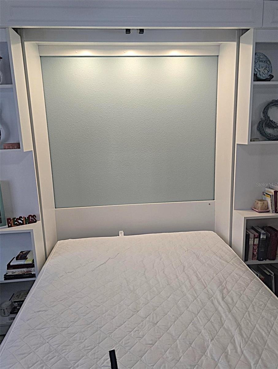 Lighted area behind and above bedding.