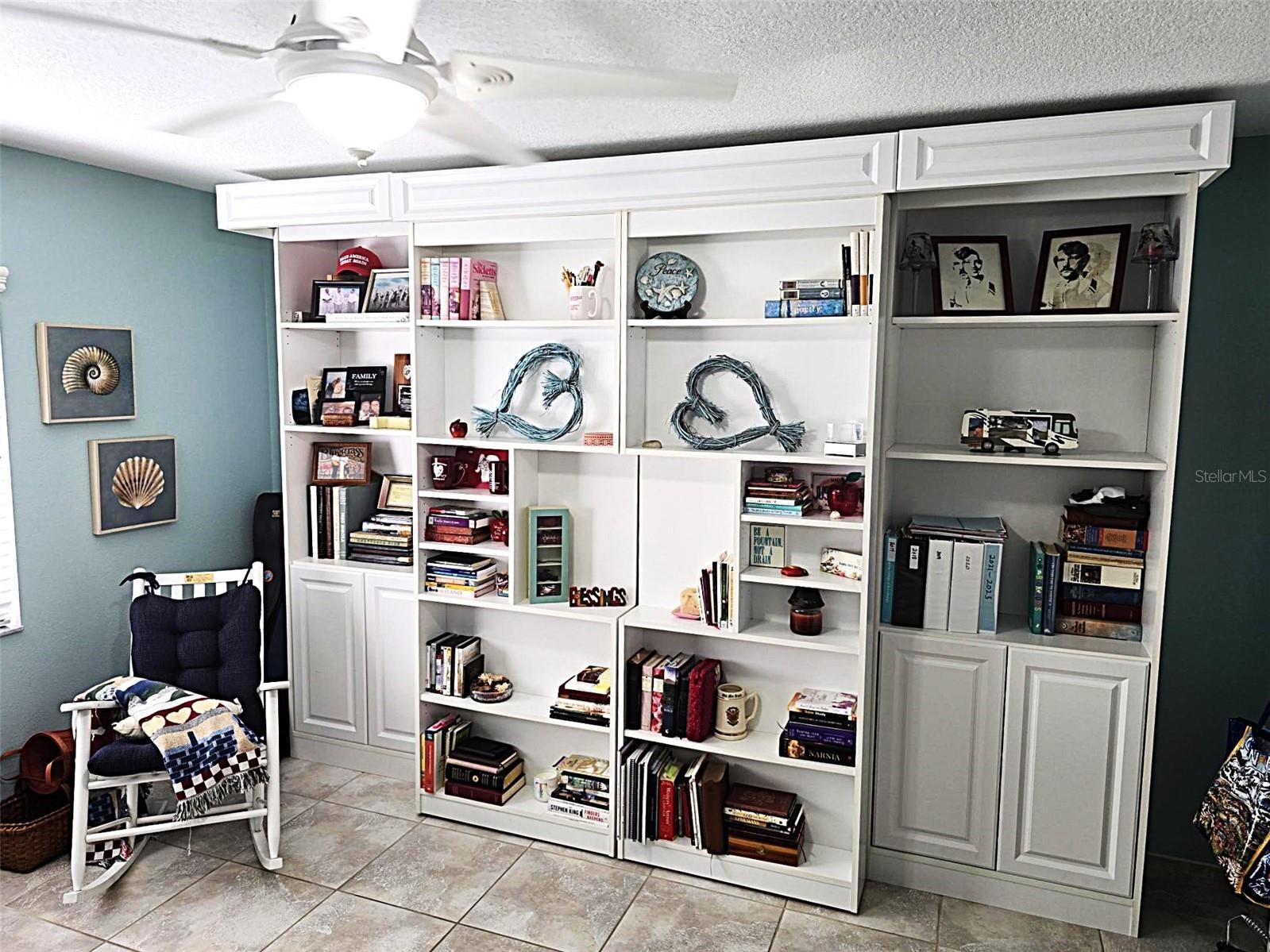 Library Style Murphy Bed shelving on rollers.