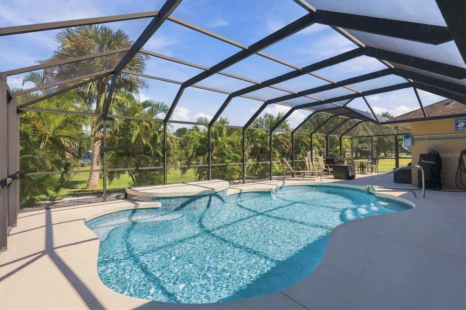 Spacious pool and deck area, with Areca Palms for privacy.