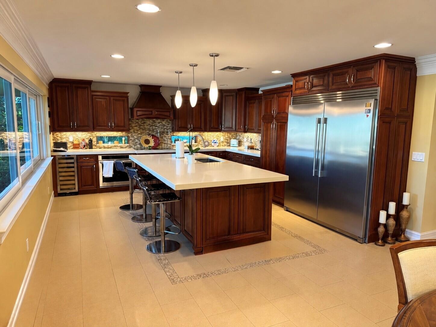 Eat in kitchen with a large island and wine cooler.