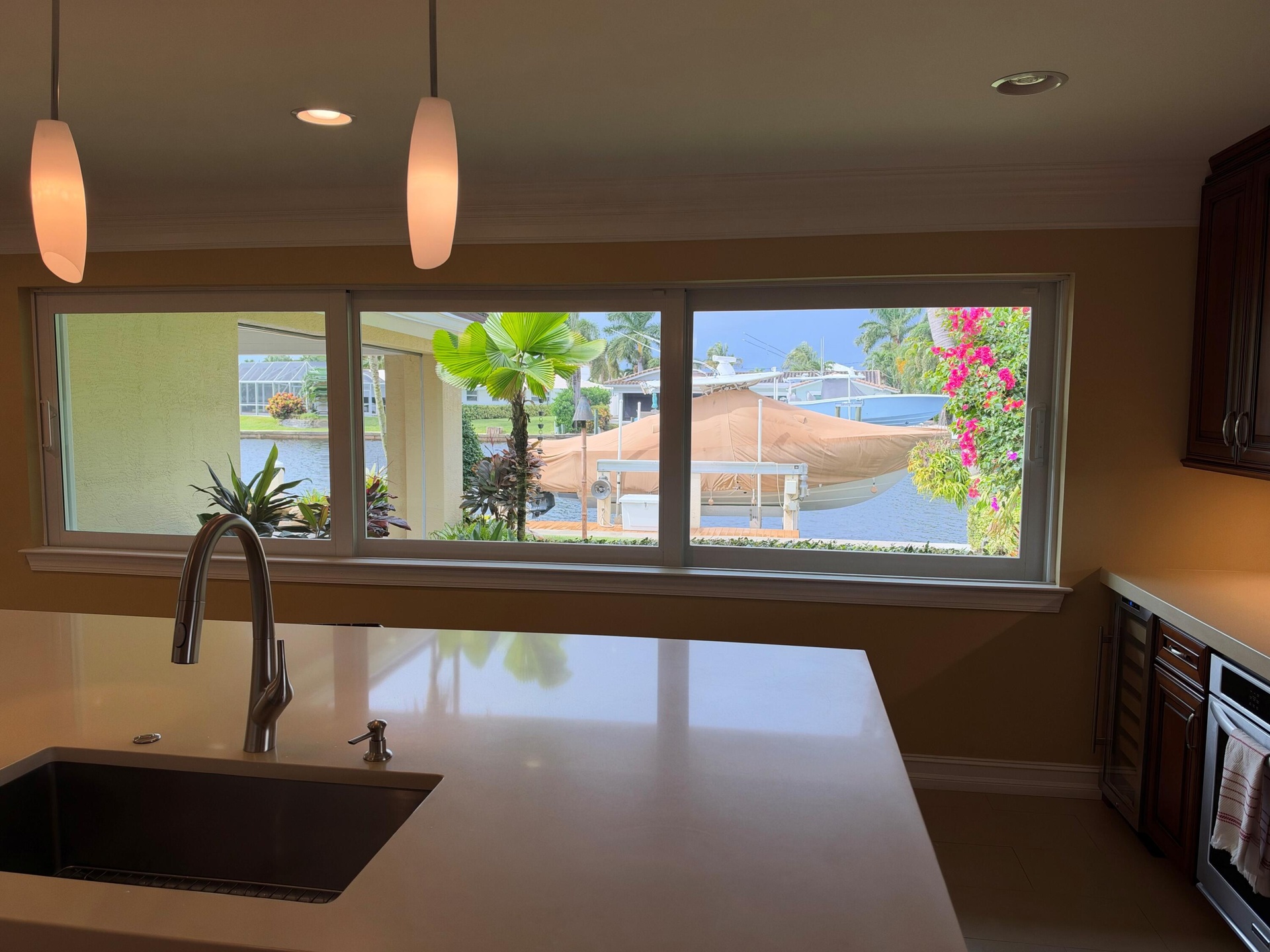 View from kitchen with sliding stacking windows with a view of the gas tiki torch.