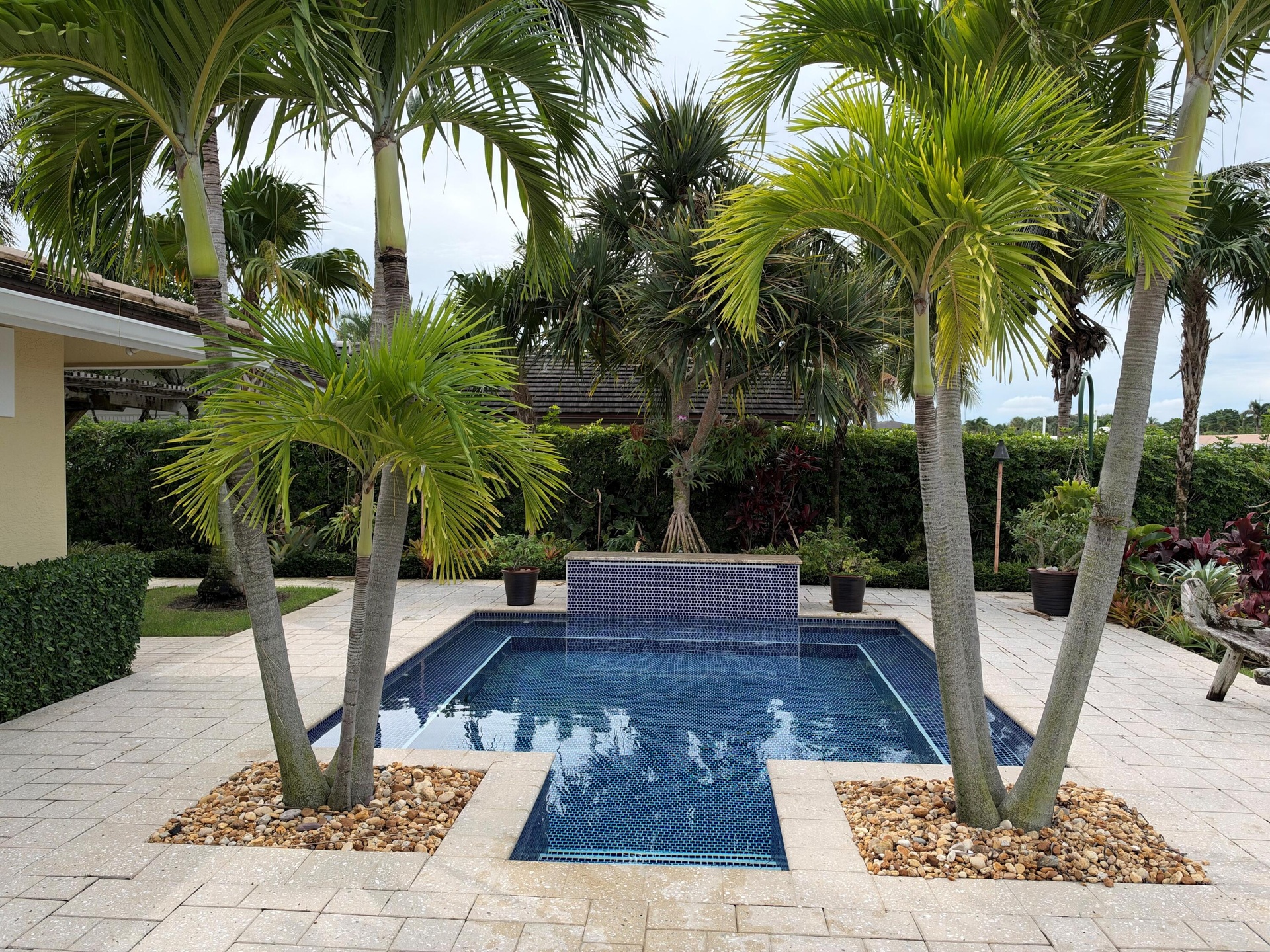 Pool with electric and gas heaters. Waterfall and bench seating throughout the pool.