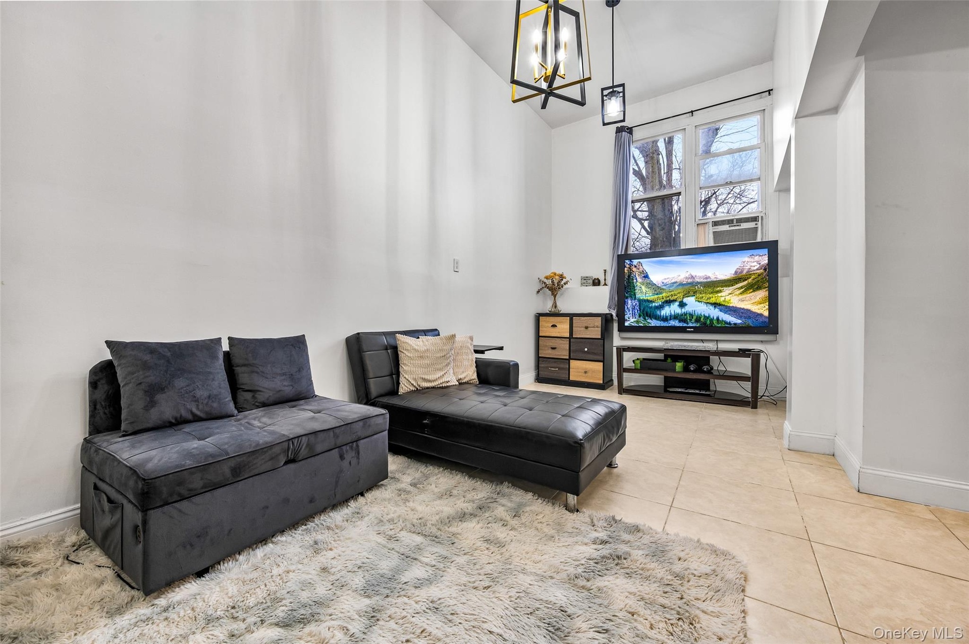 Vaulted ceilings, large-format tile flooring, and geometric pendant lighting