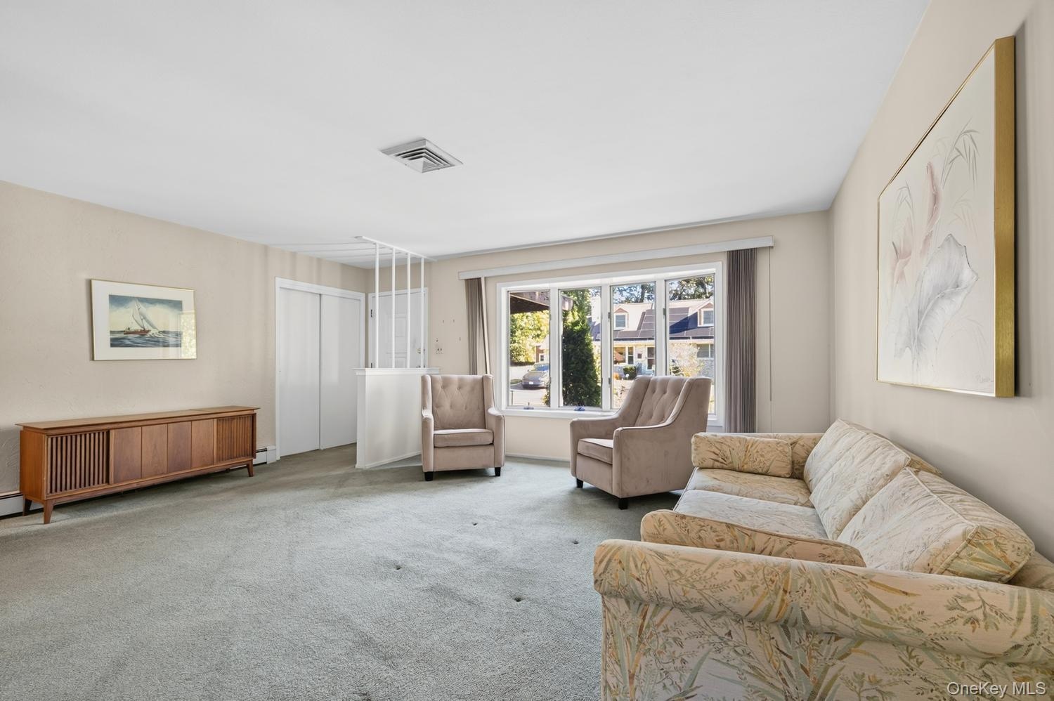 Entry to home with coat closet in spacious living room