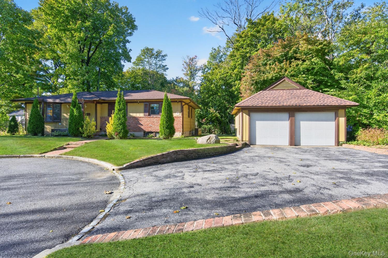 Front of home, driveway and two car garage