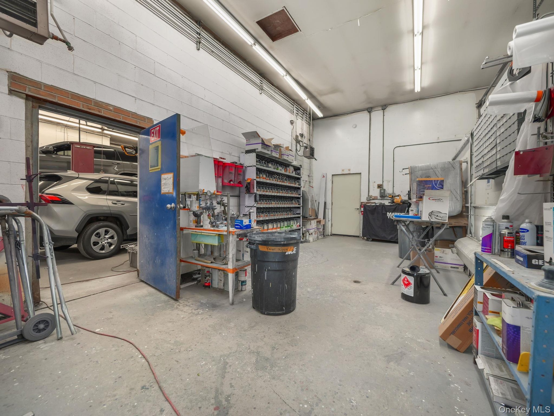 Garage featuring a workshop area and a heating unit