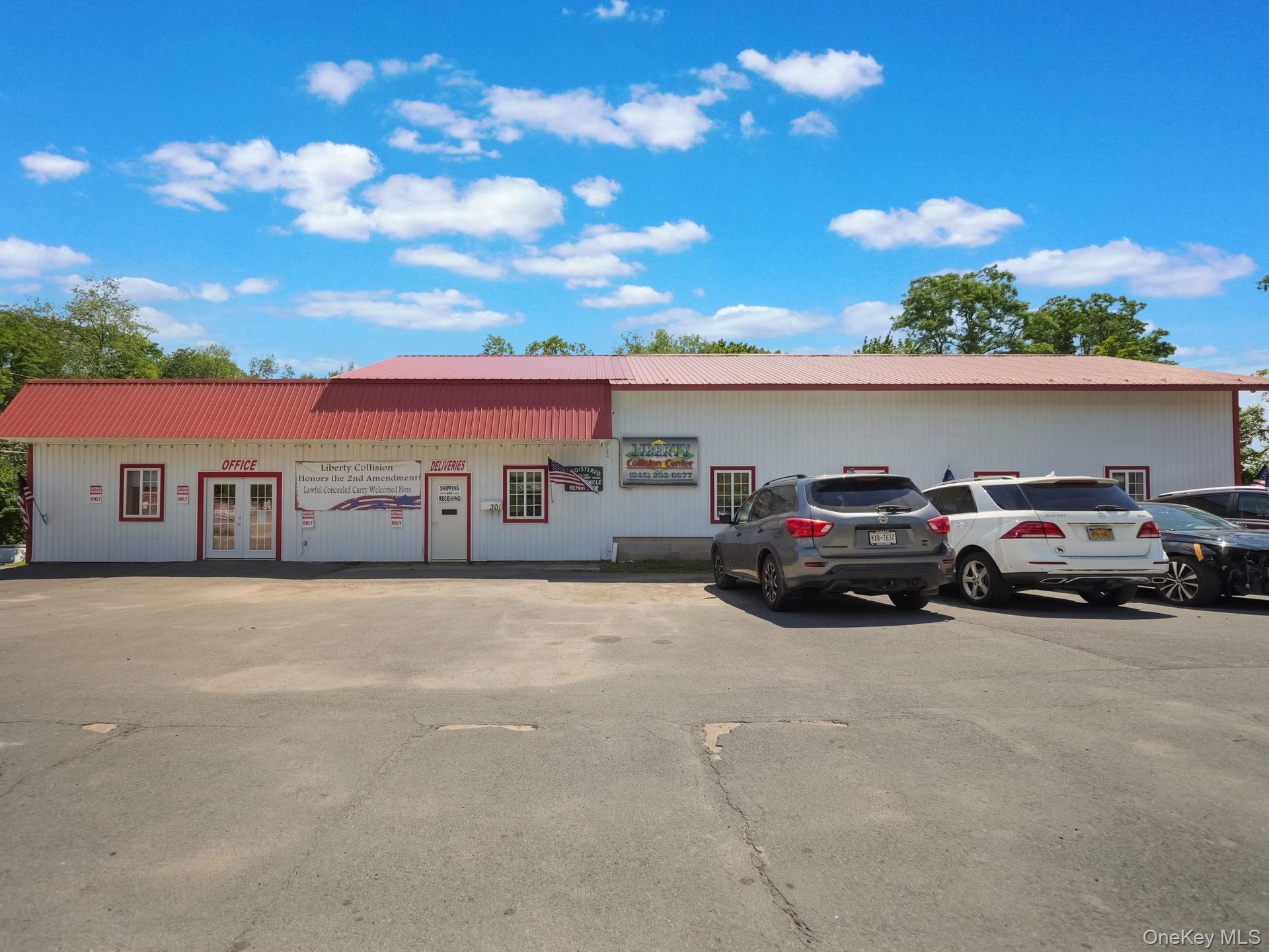 View of commercial property featuring uncovered parking