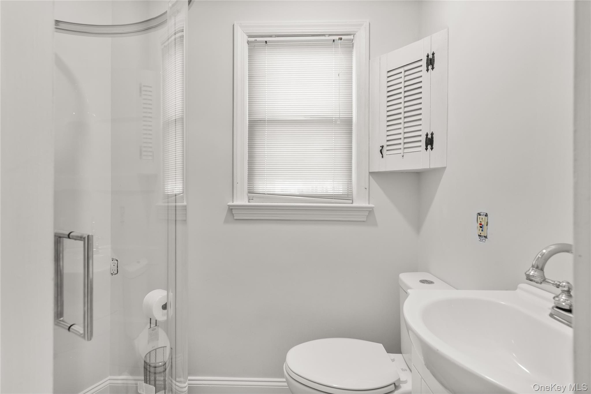 Bathroom with a shower stall and a sink