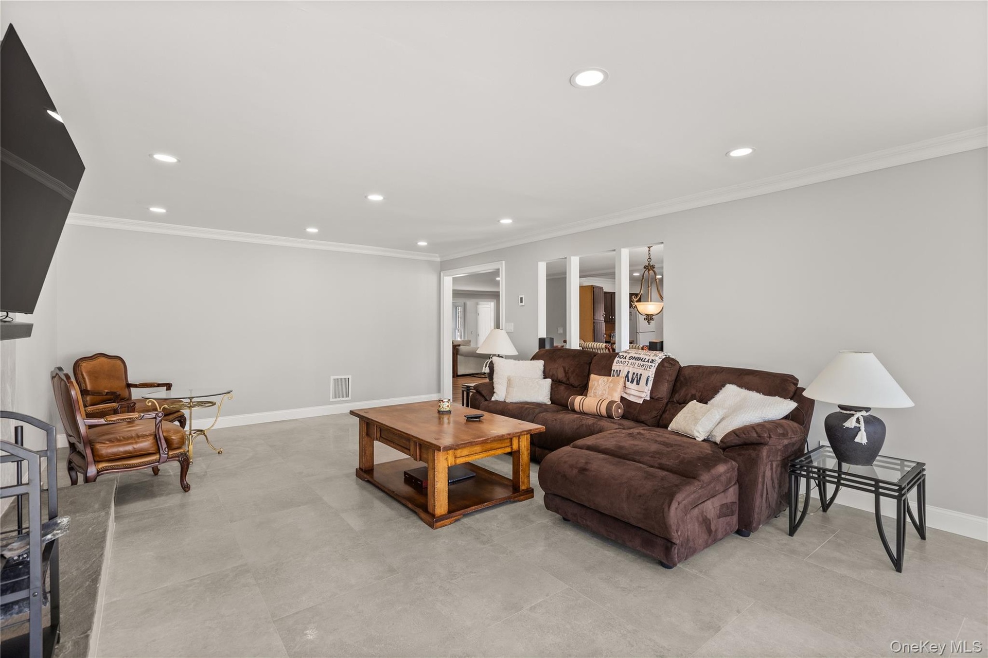 Living room featuring ornamental molding and recessed lighting