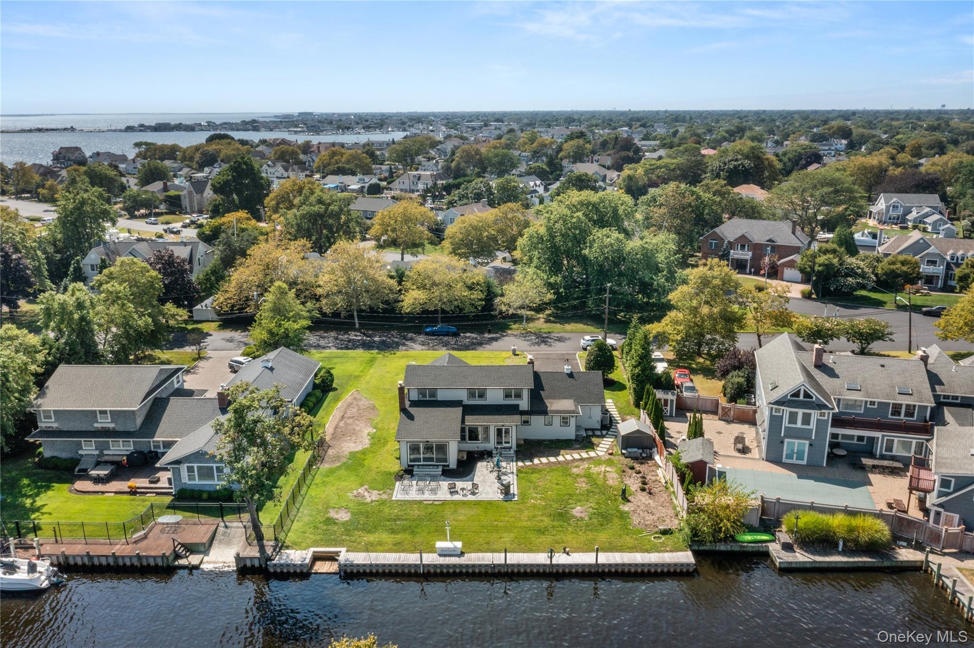 Aerial view of residential area featuring a large body of water