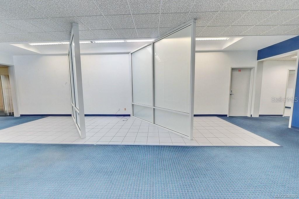 Interior view showing the open area and existing office partitions.