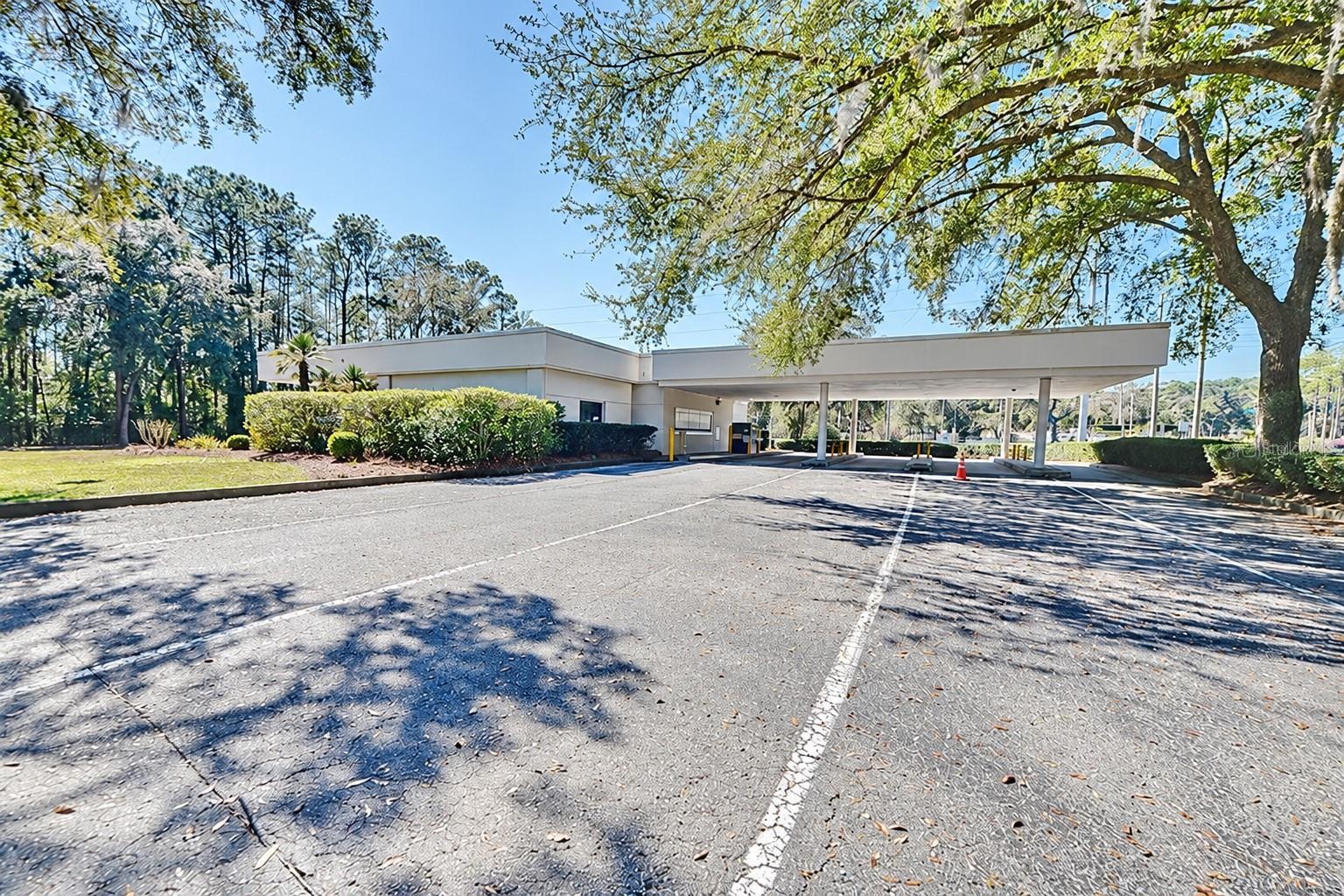 Rear view of the covered drive-through lanes. Digitally edited to remove former bank signage.