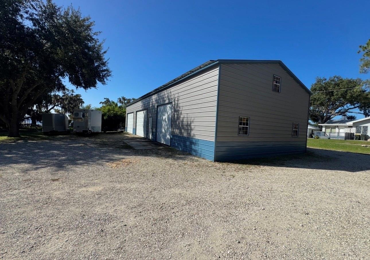 Back view of metal building. This is from the driveway on Lakeshore Dr next to detached garage apartment.