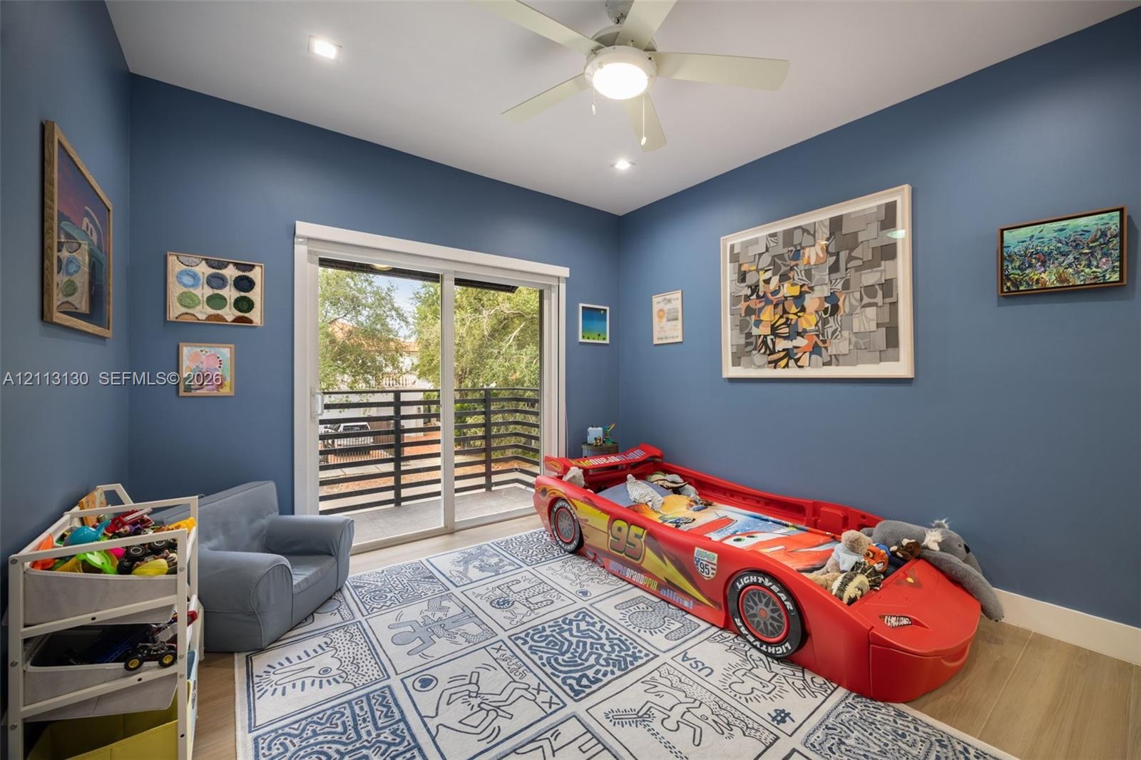Interior room featuring wood-finish flooring, recessed lighting, a ceiling fan with integrated light fixture, and sliding glass doors with balcony acc
