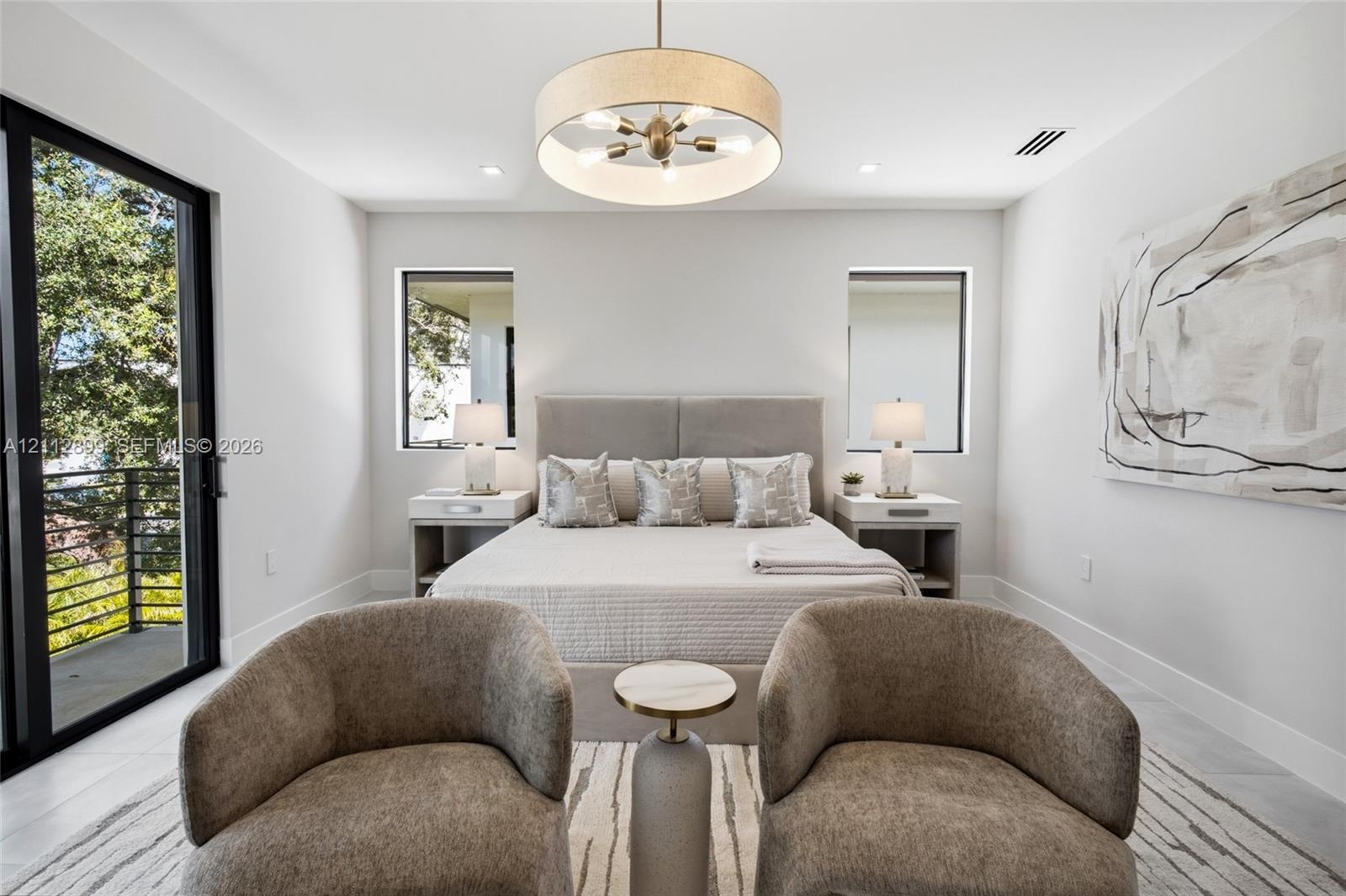 Bedroom featuring large-format tile flooring, a multi-bulb drum pendant light fixture, and black-framed sliding glass doors opening to a balcony