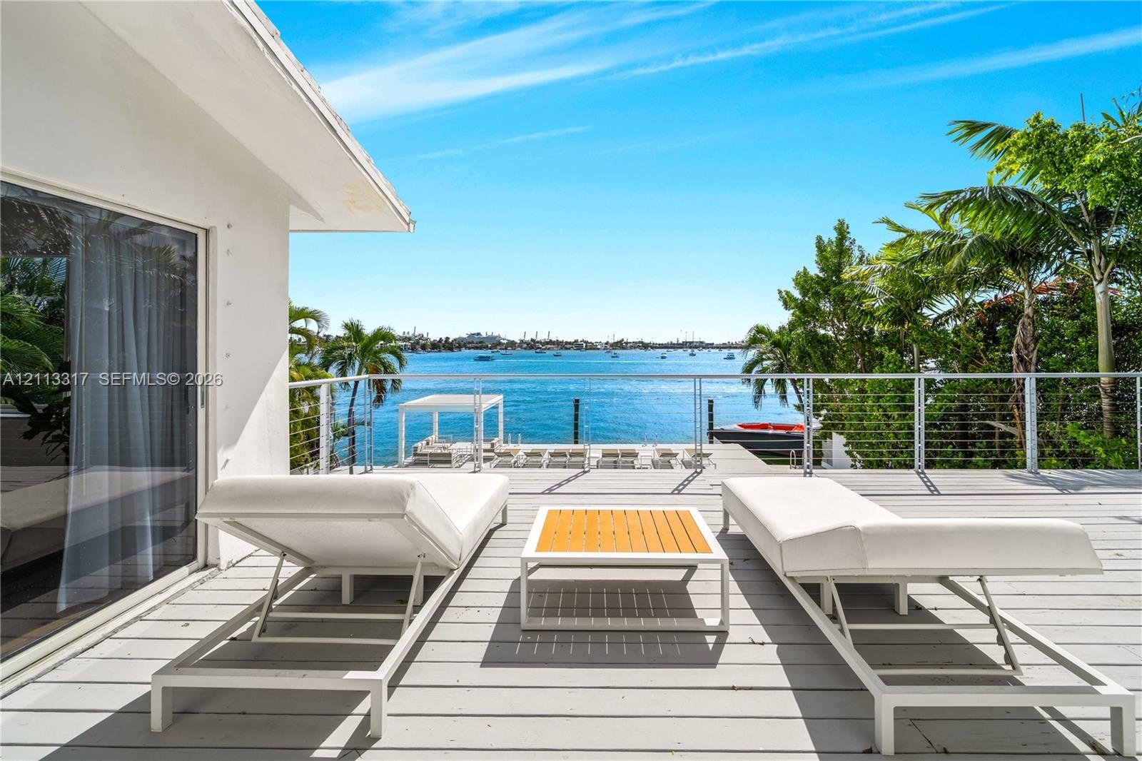 Waterfront deck with wood-finish decking and stainless steel cable railing