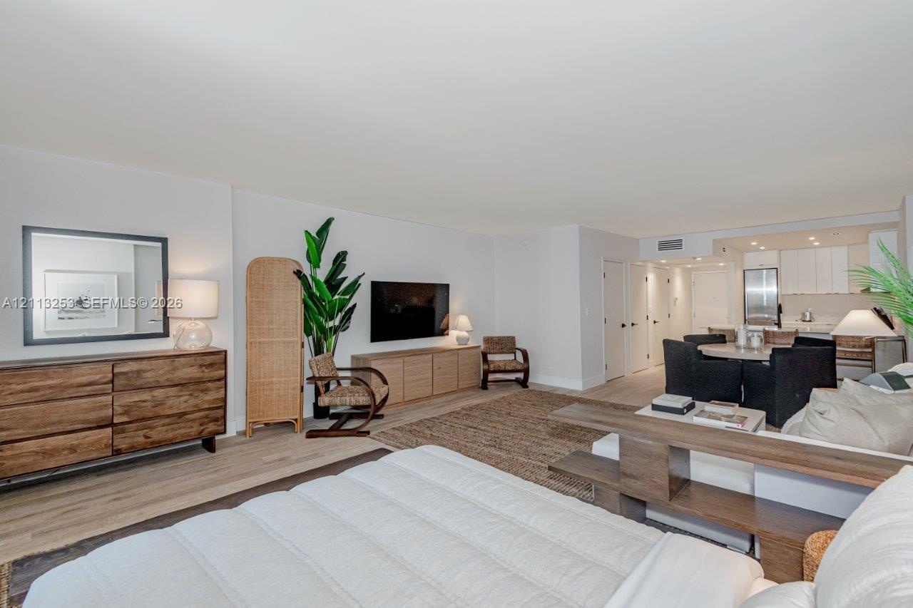 Open-concept interior featuring wood-finish flooring, neutral walls, and recessed lighting