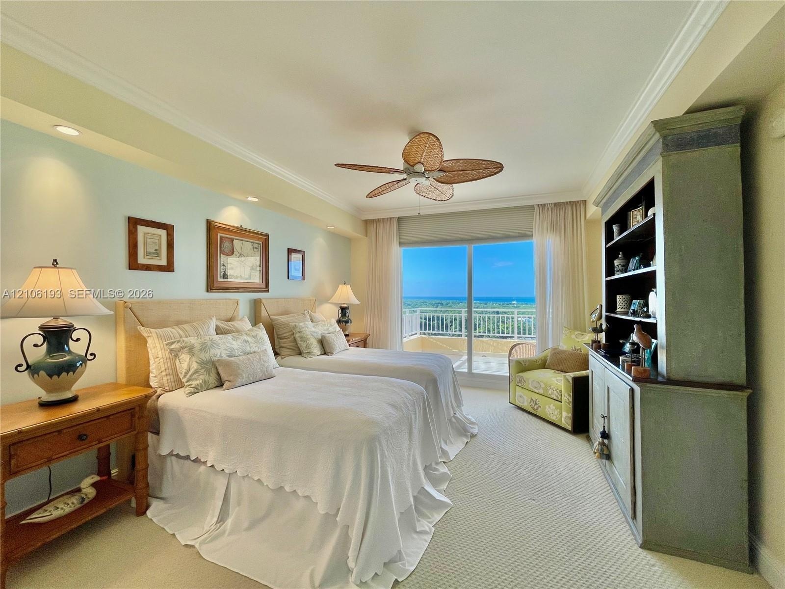 Bedroom featuring crown molding, recessed lighting, a ceiling fan with woven blades, built-in cabinetry, and sliding glass doors with direct access to
