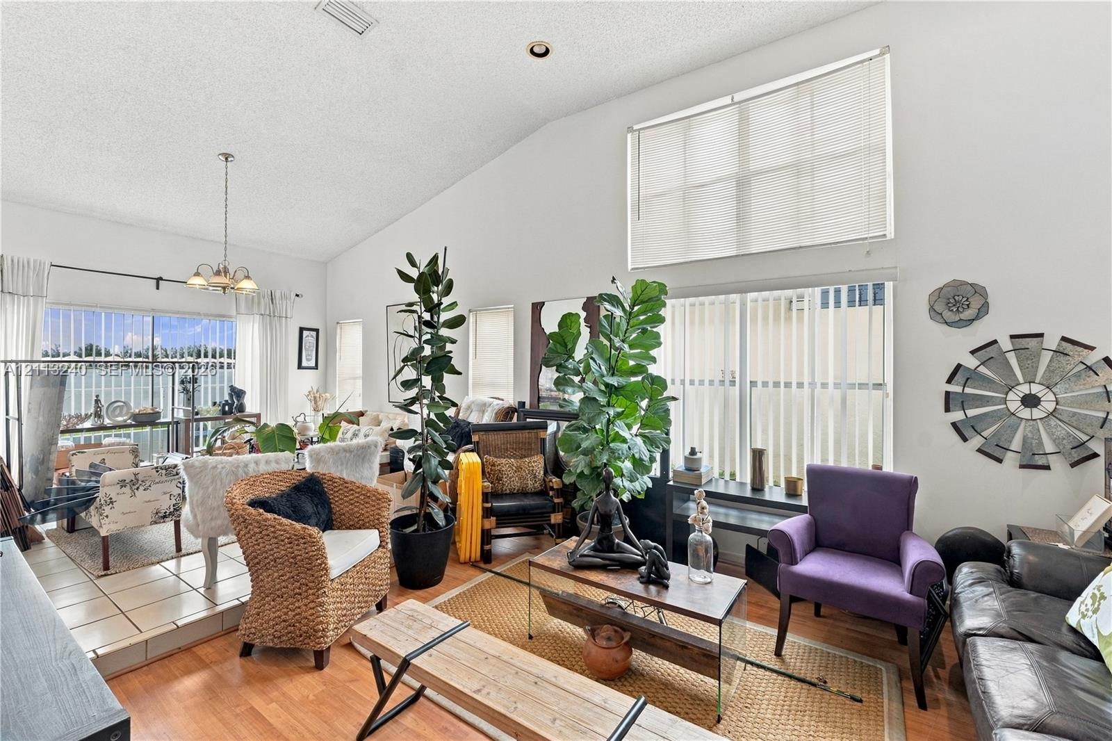 Vaulted ceilings, expansive multi-pane windows, elevated tile platform, and wood-finish flooring