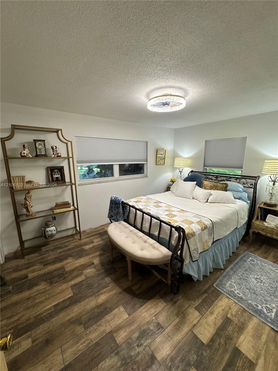 Wood-finish flooring, recessed ceiling lighting, and horizontal window shades