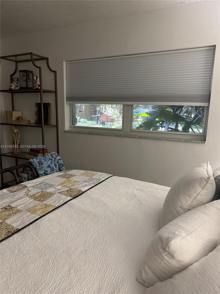 Horizontal window featuring a stone sill and pleated top-down shade