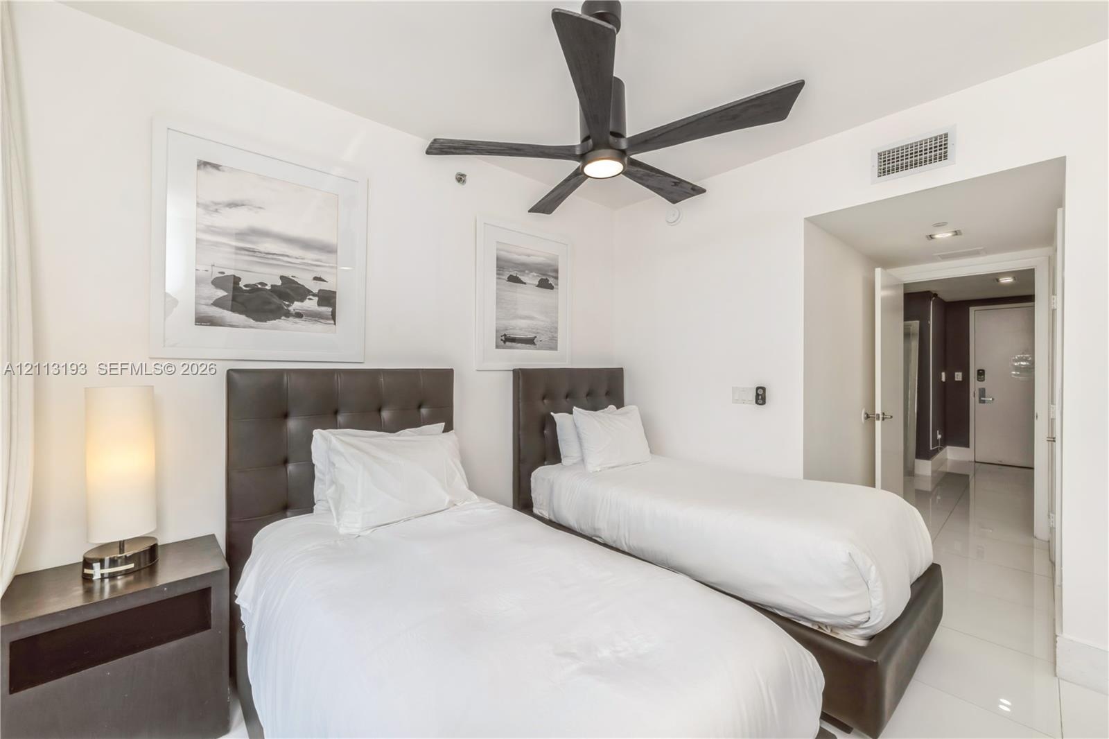 Polished tile flooring, matte black five-blade ceiling fan, and recessed lighting
