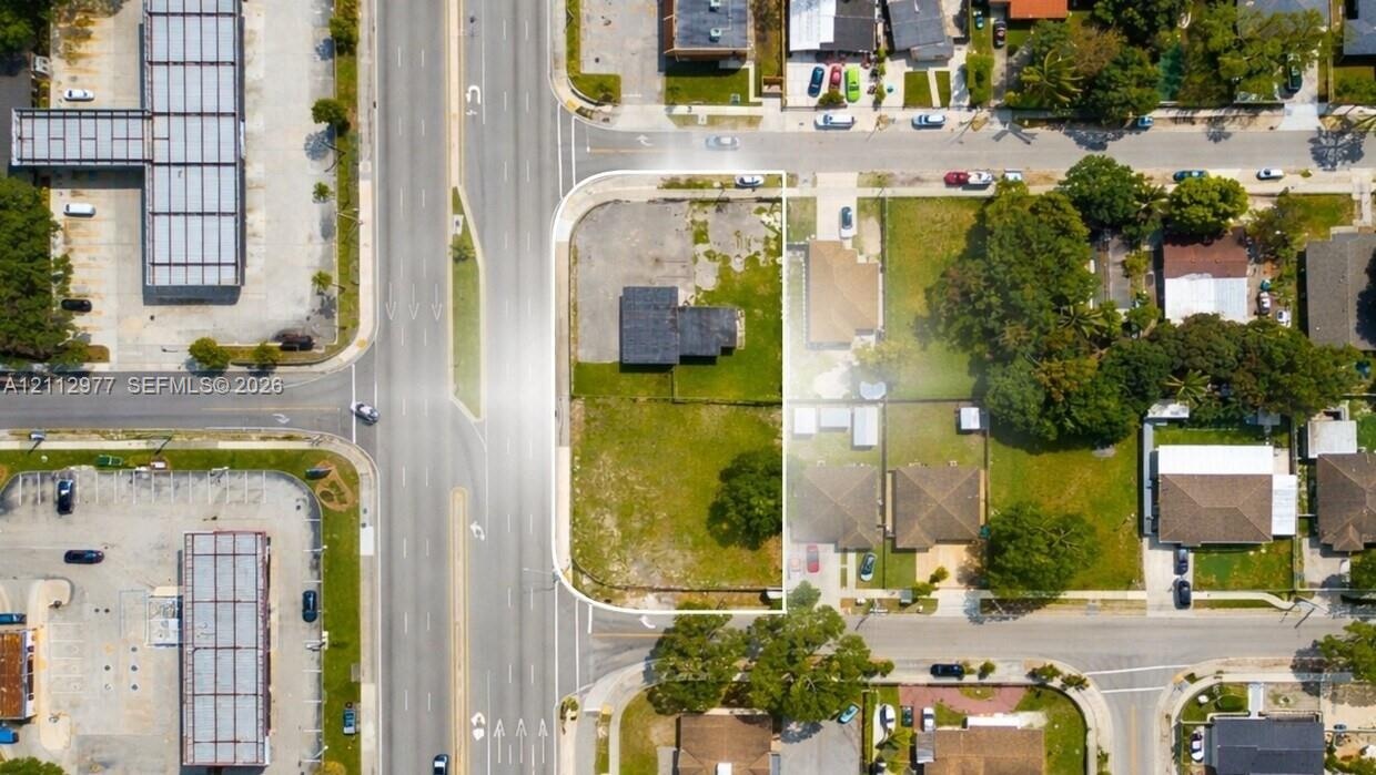 Corner lot featuring street frontage, cleared land, and mature perimeter trees