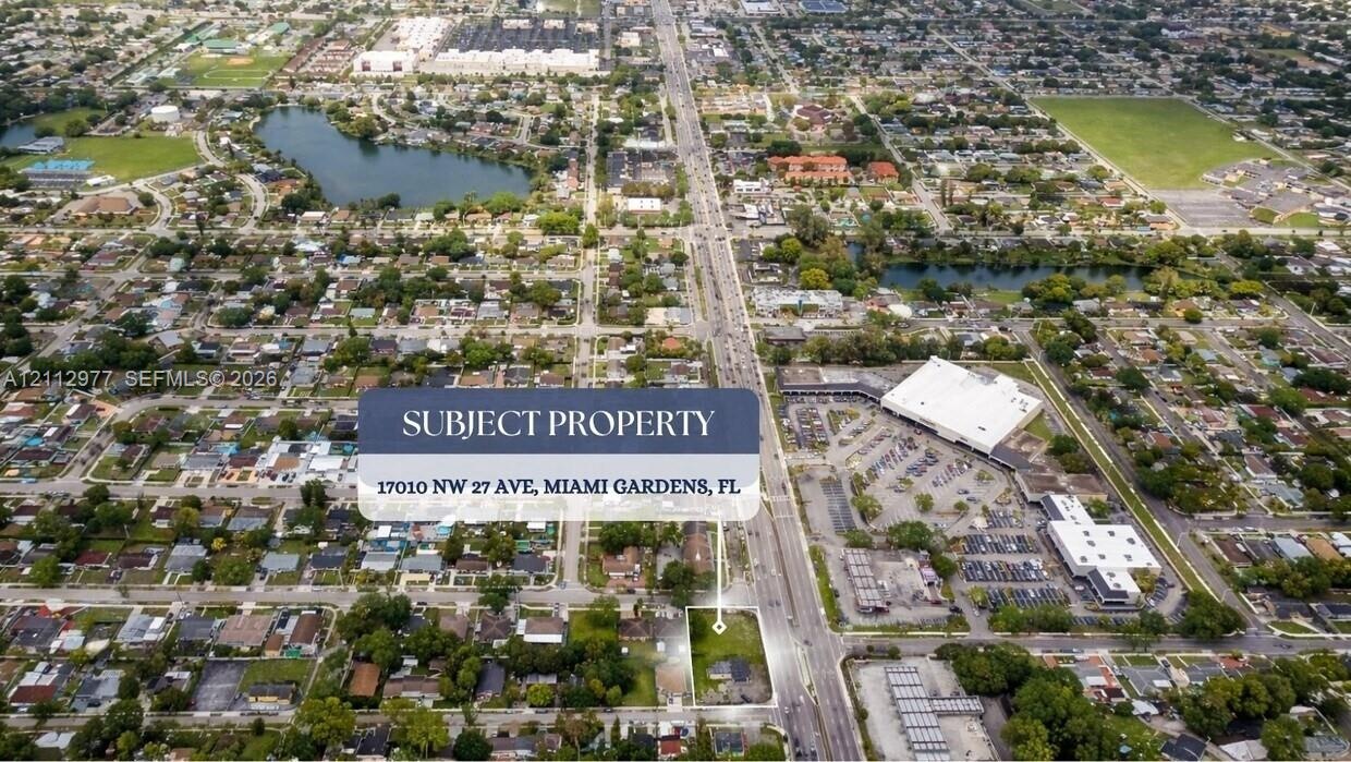 Aerial perspective of corner lot property featuring direct frontage on NW 27th Avenue in Miami Gardens