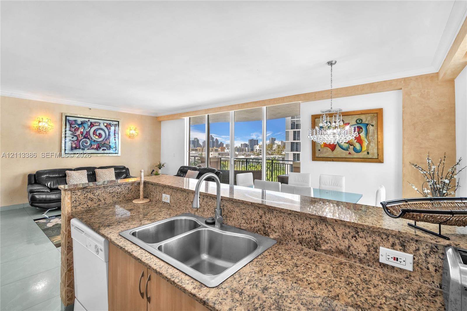 Kitchen area featuring stone-surface countertops, dual-basin under-mount sink, gooseneck faucet, built-in dishwasher, and wood-finish cabinetry