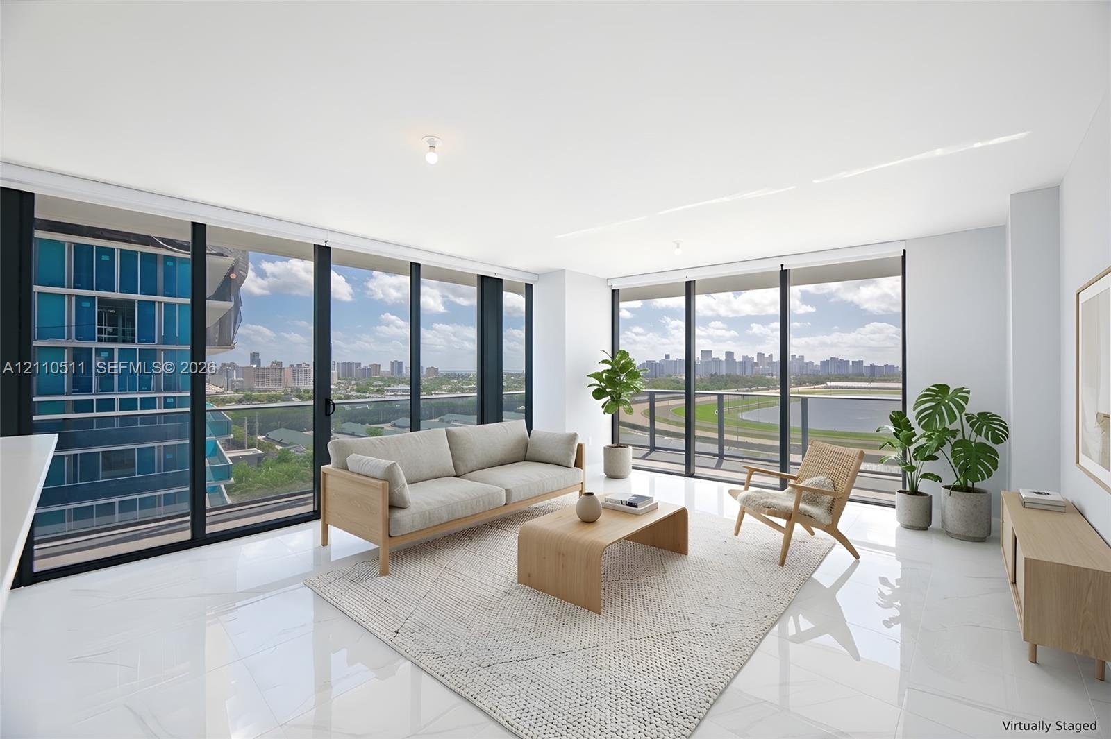 Floor-to-ceiling windows featuring panoramic city and track scenery, complemented by polished tile flooring and recessed ceiling lighting