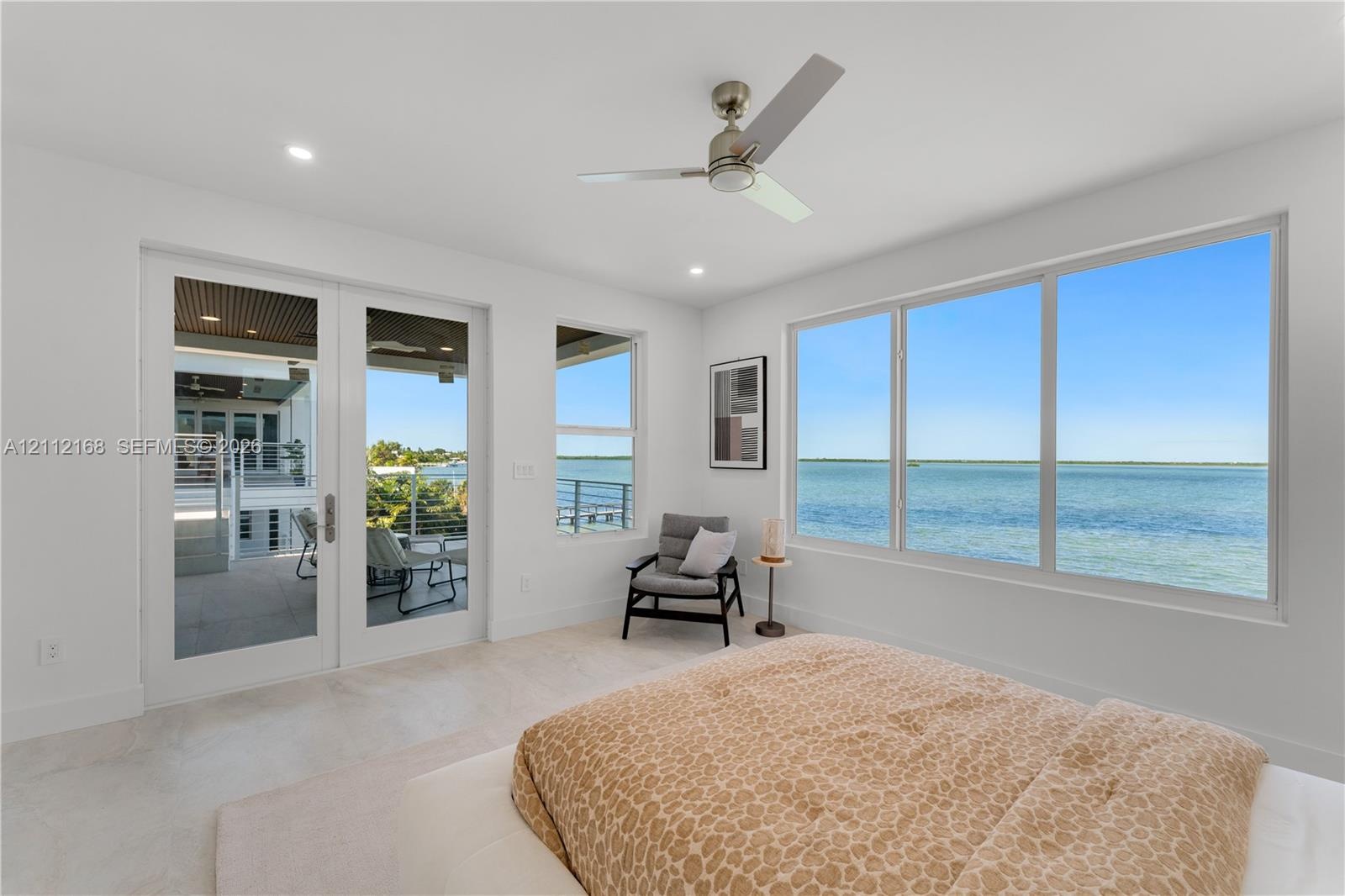 Floor-to-ceiling windows, double glass doors with access to the exterior, recessed lighting, brushed nickel ceiling fan, and light-toned tile flooring