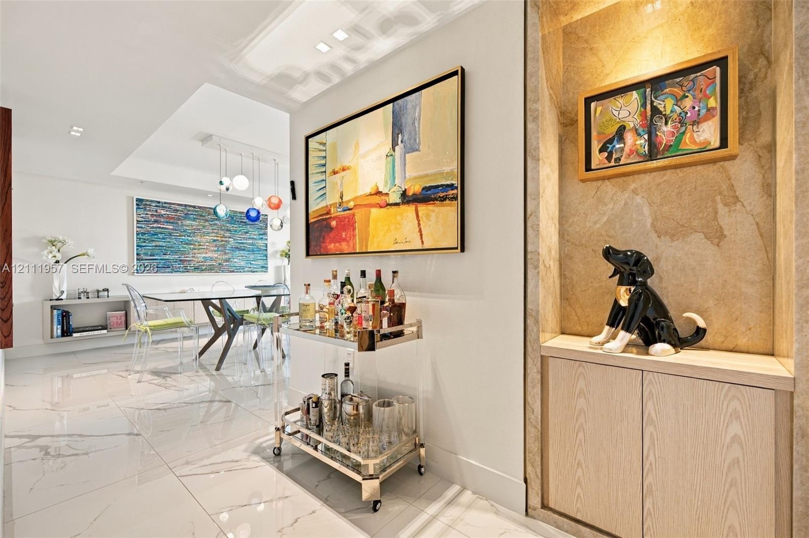 Interior featuring recessed stone-clad display alcove with built-in cabinetry, polished tile flooring with marble-style veining, recessed ceiling ligh