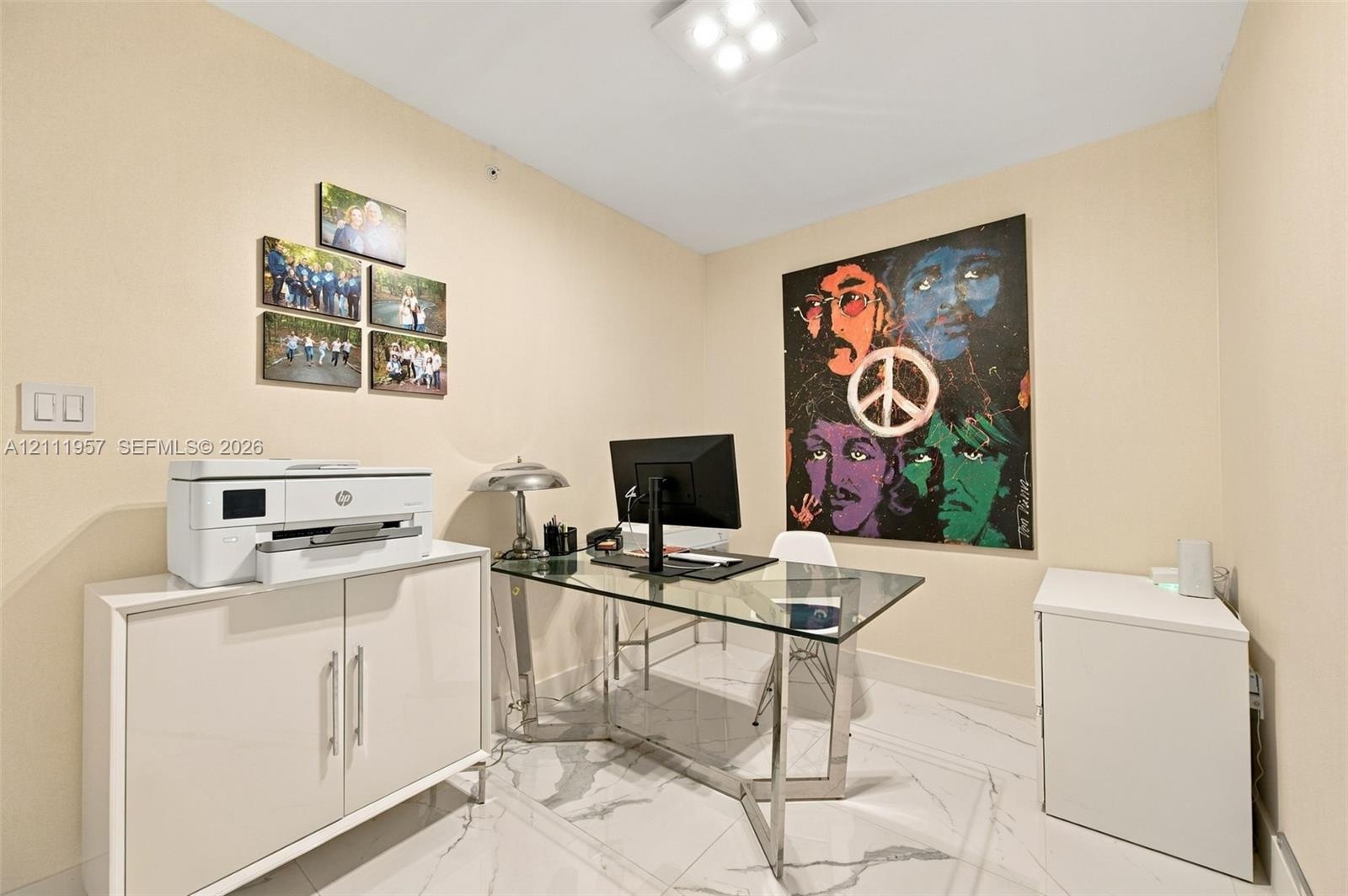 Interior room featuring high-gloss white built-in cabinetry, polished stone-finish flooring with grey veining, and a flush-mount square LED light fixt