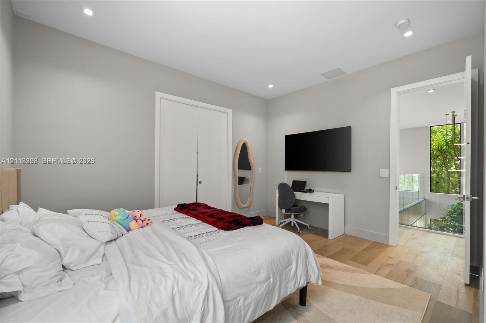 Wood-finish flooring, recessed lighting, and dual-panel interior doors
