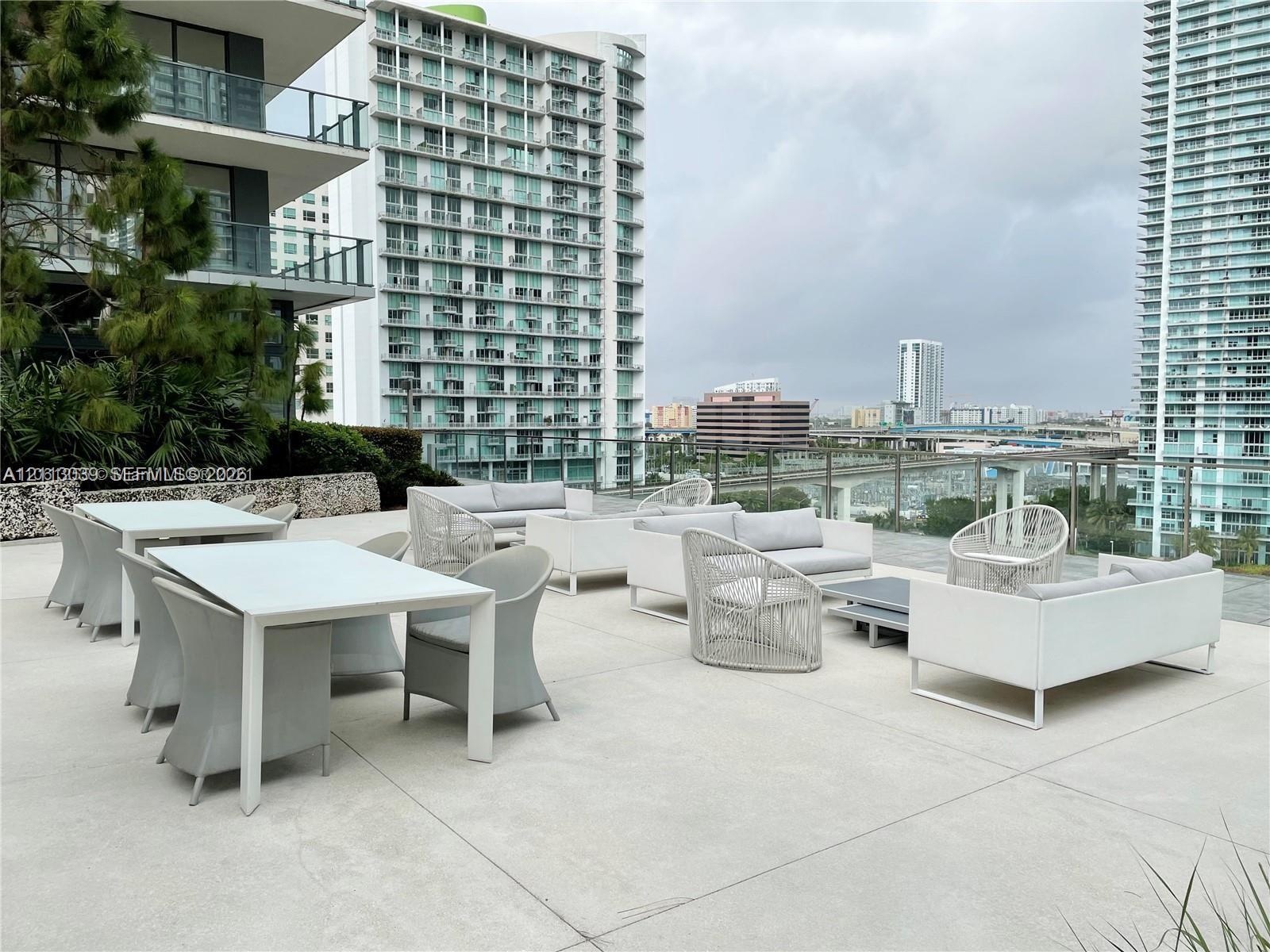 Expansive outdoor terrace featuring concrete flooring and a glass railing
