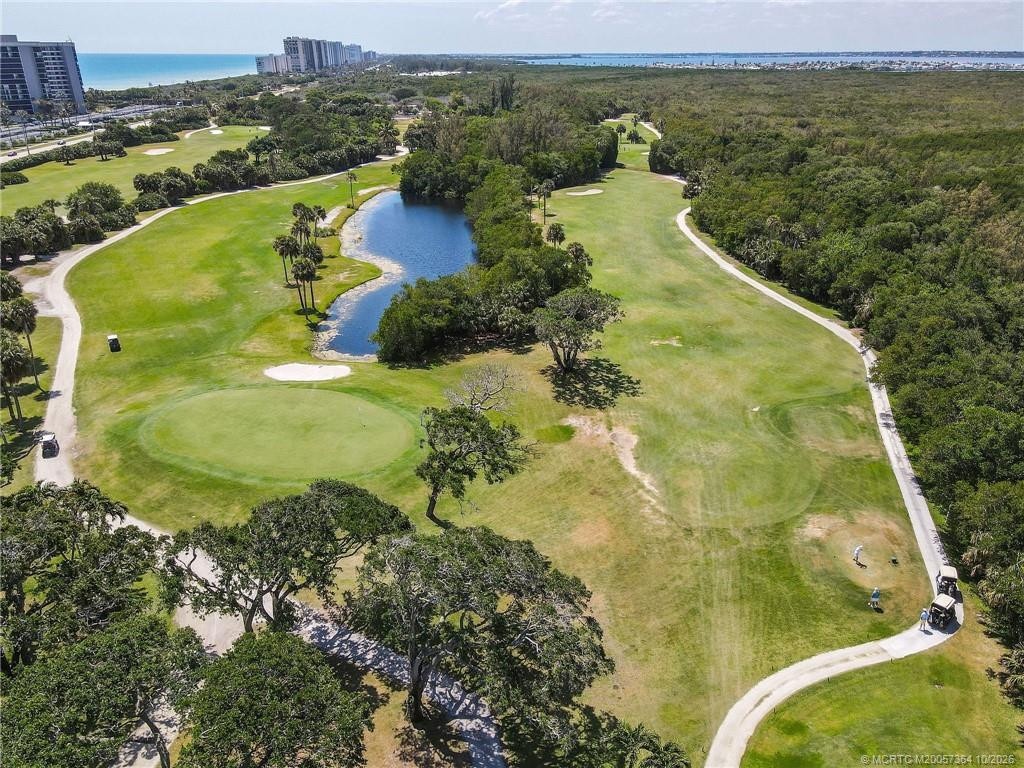 Enjoy the beautifully landscaped 9-hole golf course at Island Dunes Country Club, featuring lush fairways, scenic ponds, and a peaceful natural settin