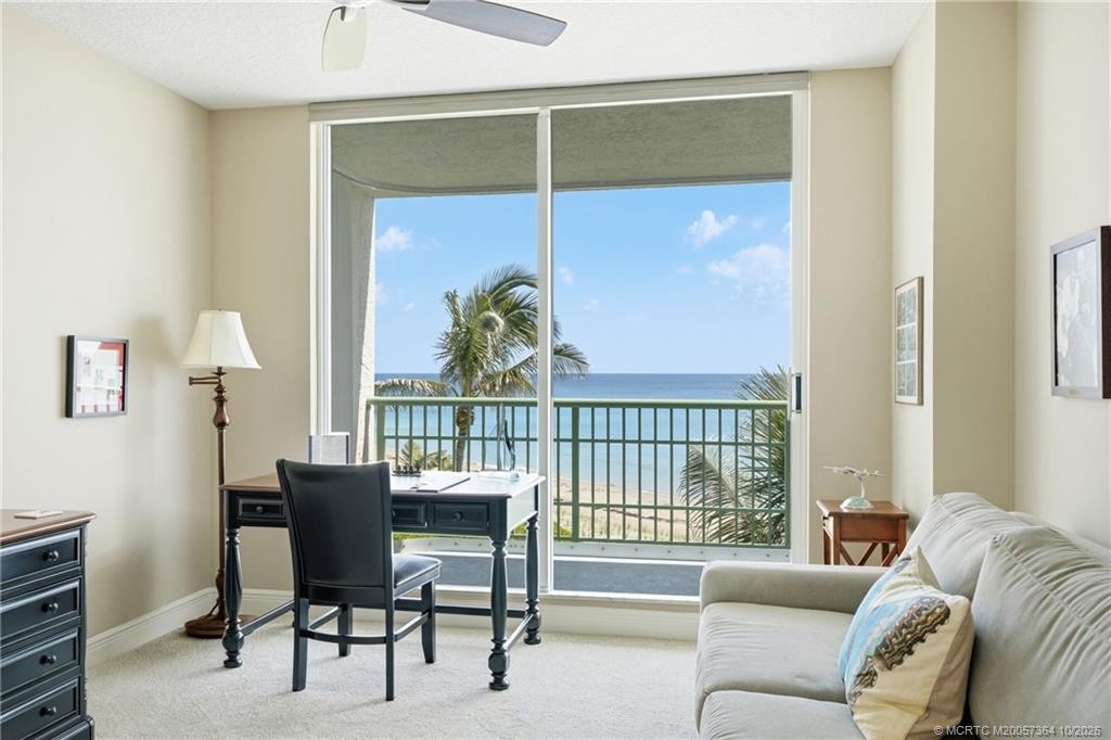 Enjoy beautiful Atlantic Ocean views and swaying palm trees from this oceanfront bedroom, currently arranged as a home office.