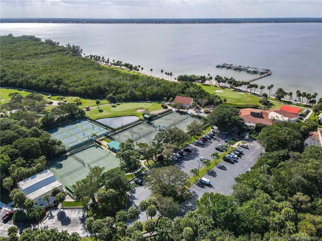Aerial view of Island Dunes Country Club featuring tennis courts, pickleball courts, a golf course, and the scenic Indian River Lagoon.