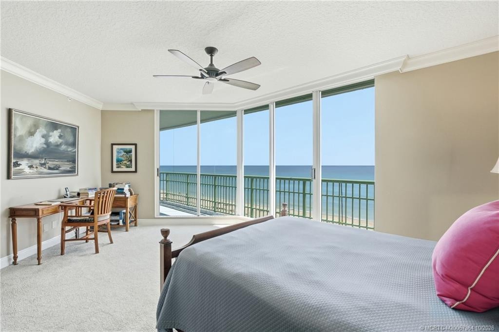 Wake up to breathtaking Atlantic Ocean views from this spacious primary bedroom with floor-to-ceiling glass.