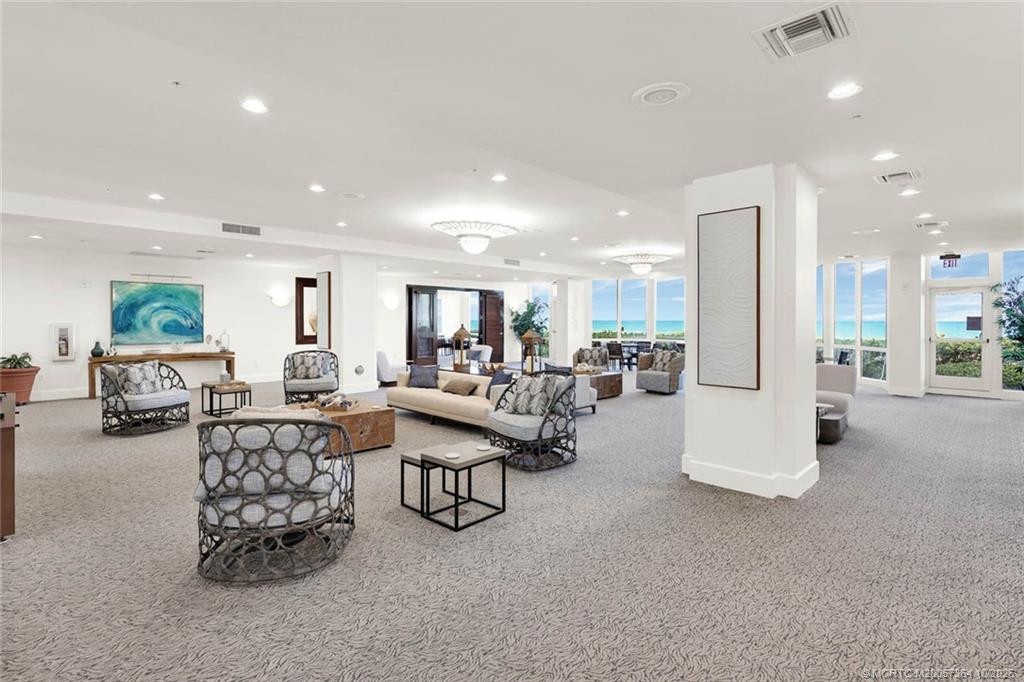 Enjoy an inviting oceanfront gathering space with comfortable seating, a bar area, and breathtaking ocean views.