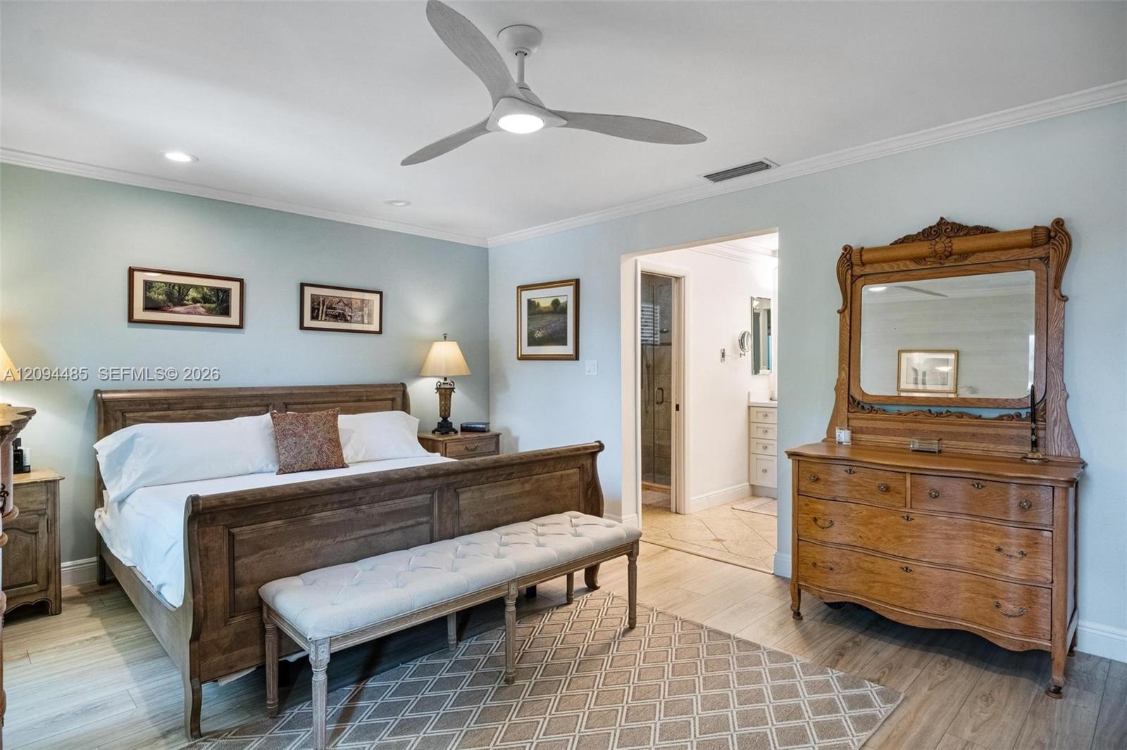 Spacious room featuring wood-finish flooring, recessed lighting, and a modern three-blade ceiling fan