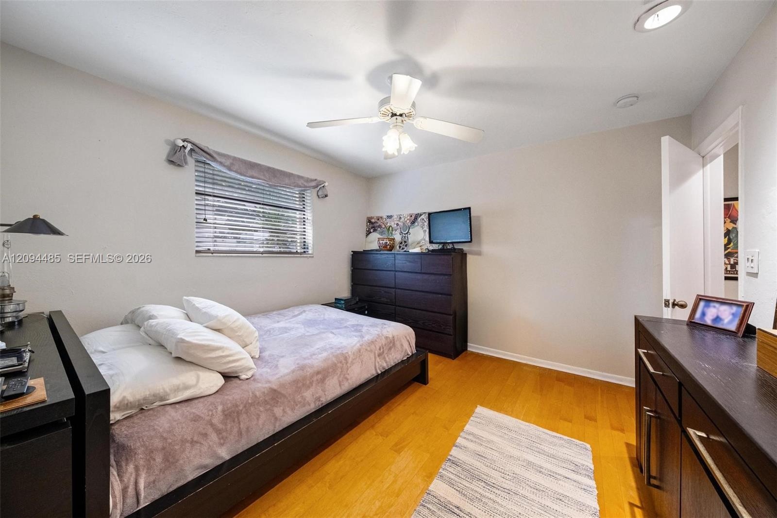 Wood-finish flooring, recessed lighting, and a ceiling fan with integrated light fixture