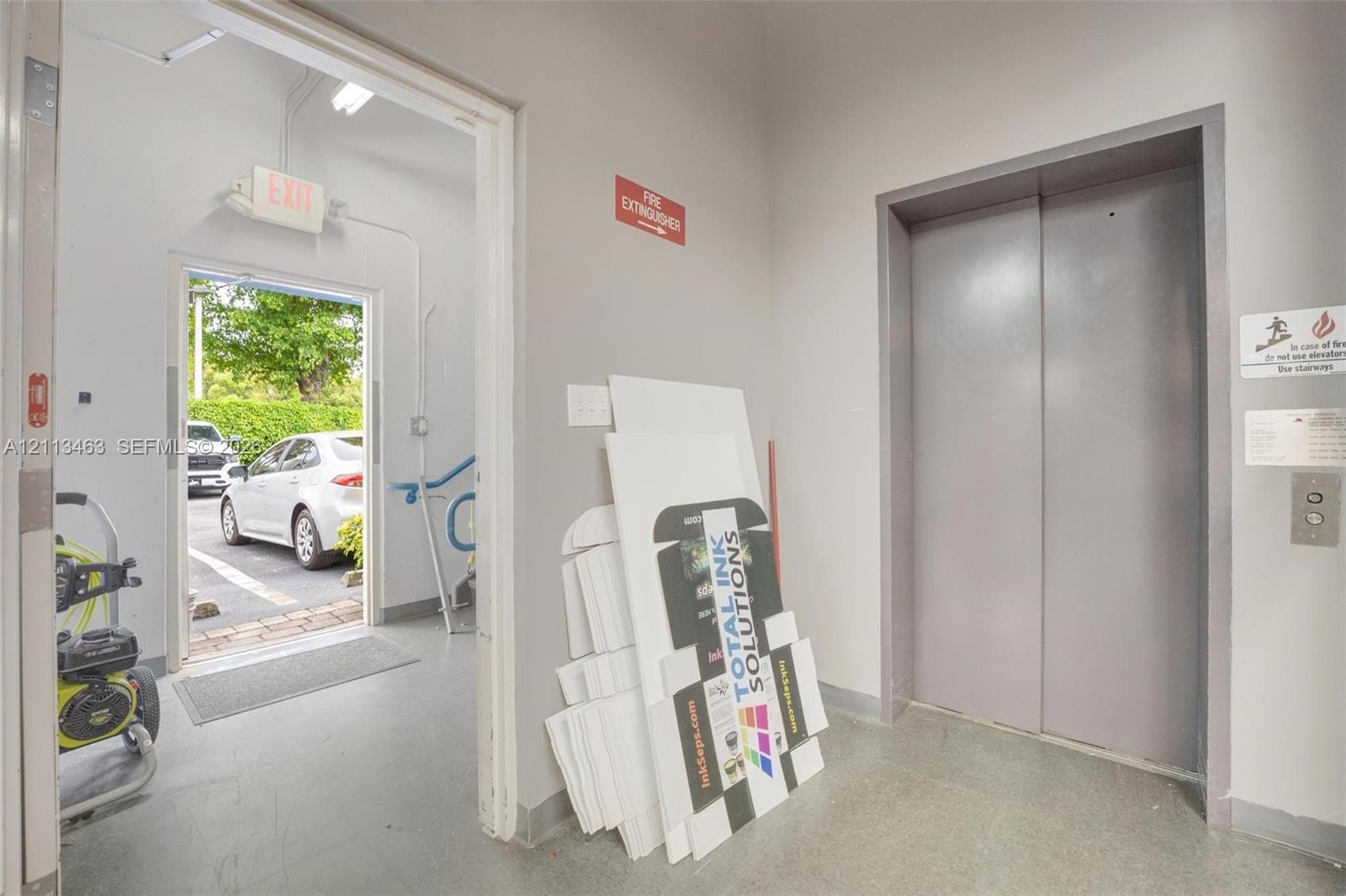 Elevator access featuring painted metal sliding doors and a dedicated exterior doorway